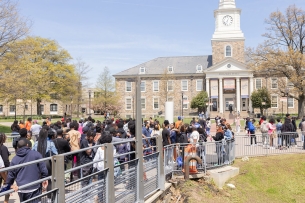 A line of prospective students stands in front of an academic building on Morgan State University's Baltimore campus.