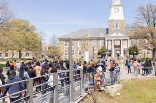 A line of prospective students stands in front of an academic building on Morgan State University's Baltimore campus. 