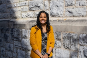 Chanit'a Holmes, pictured at the Virginia Tech campus in a yellow cardigan.