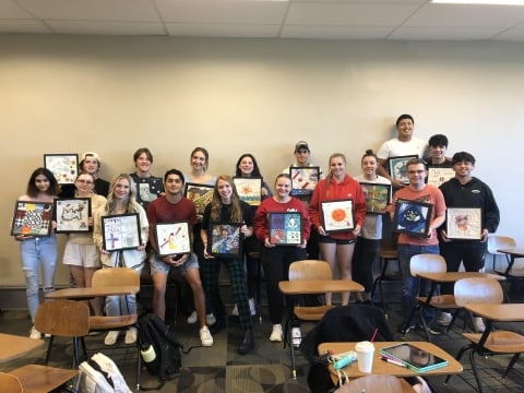 The students in the author’s fall 2022 first-year seminar hold their quilt squares.