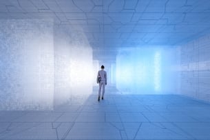 Lone woman walks with back to viewer in a futuristic room