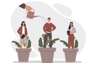 Two women and one man stand in a pot with plants while a hand above pours water from a watering can on them