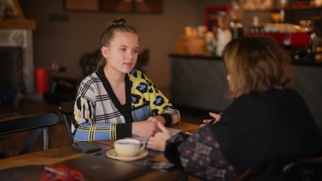 Two women meet in a cafe and talk