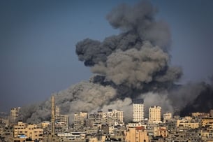 An overhead view of smoke billowing over Gaza City in the aftermath of Israeli air strikes.