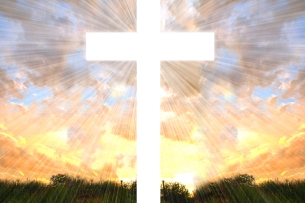 A white cross, lit by sunlight, against a pink and blue sky. 