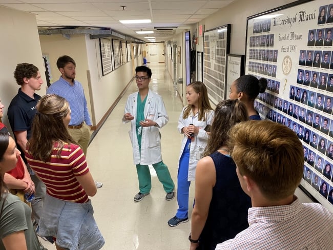 Two medical students at the University of Miami give a tour to Davidson College student athletes.