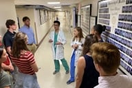 Two medical students at the University of Miami give a tour to Davidson College student athletes.