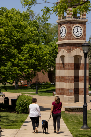 Rossi walks on UWL’s campus with his two handlers.