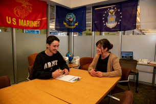 A student veteran works with a staff member at Central Oregon Community College's veteran lounge.